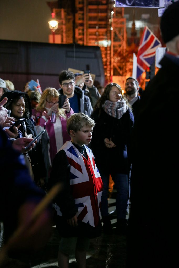 Young boy wearing British flag
