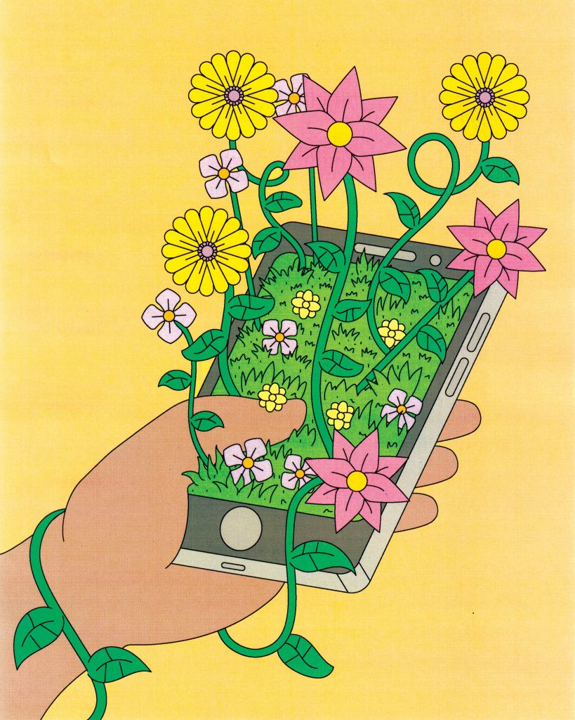 Hand holding phone with flowers growing out of it