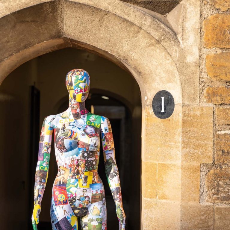 Mannequin covered in CAM magazine covers standing in college doorway
