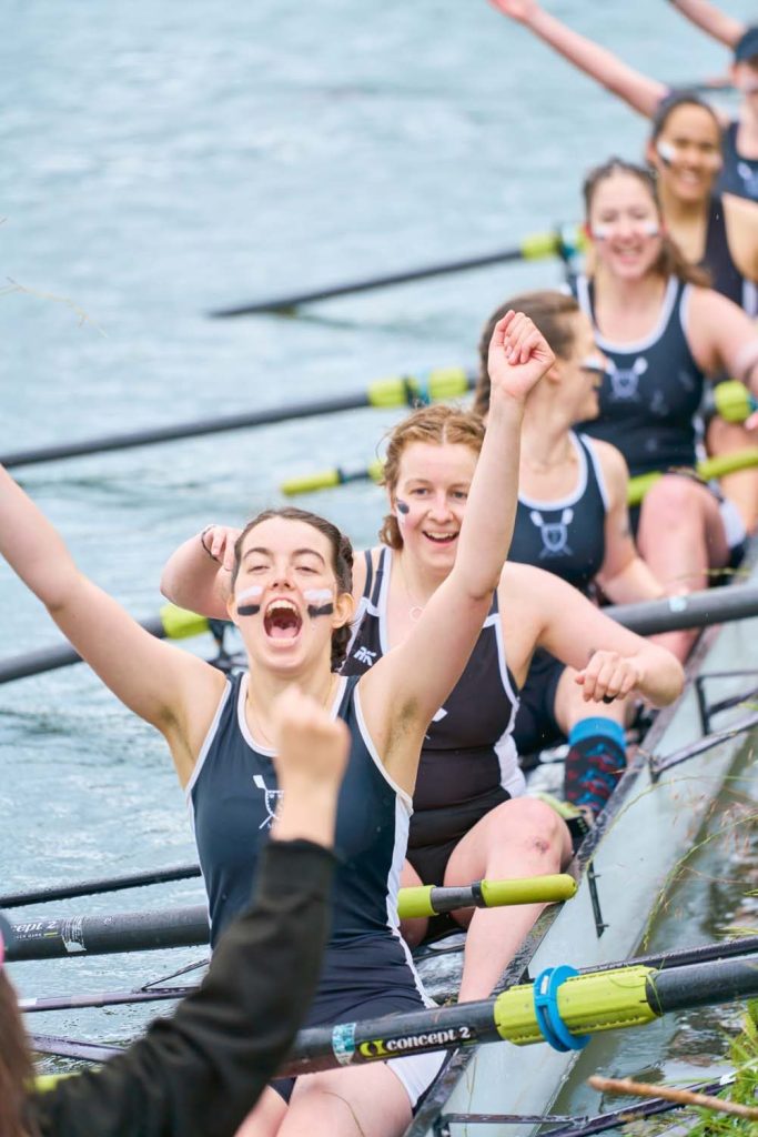 Students cheering in boat