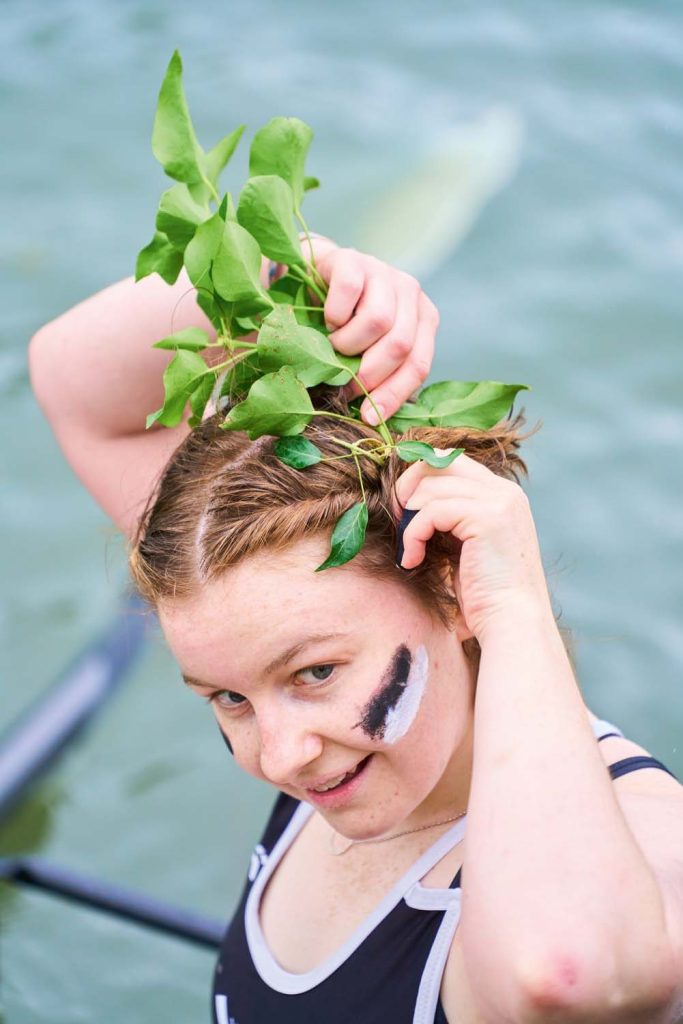 Student putting branch in hair